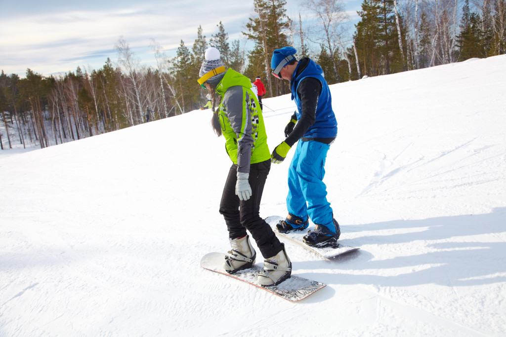 Young couple snowboarders