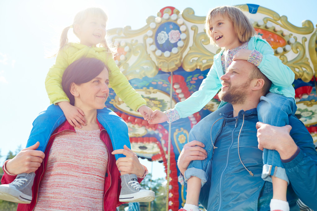 married couple with two kids in amusement park