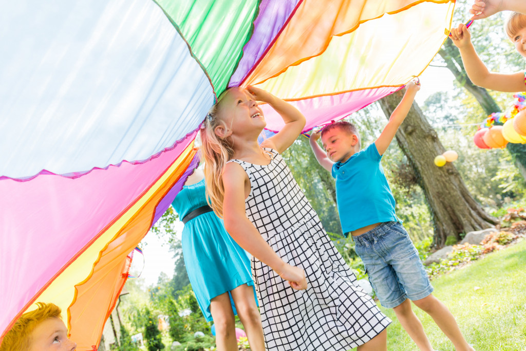 kids happily playing outdoors for an active birthday party