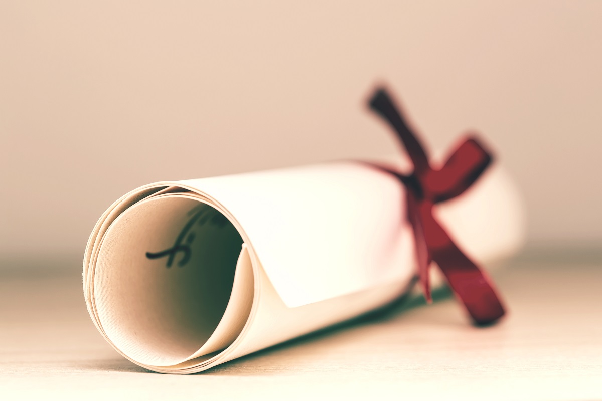 An image of a rolled certificate with ribbon