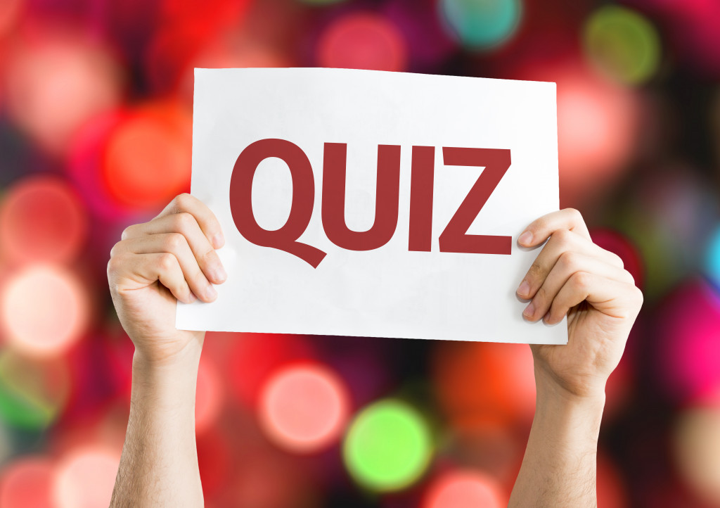 A person holding a sign with the word QUIZ